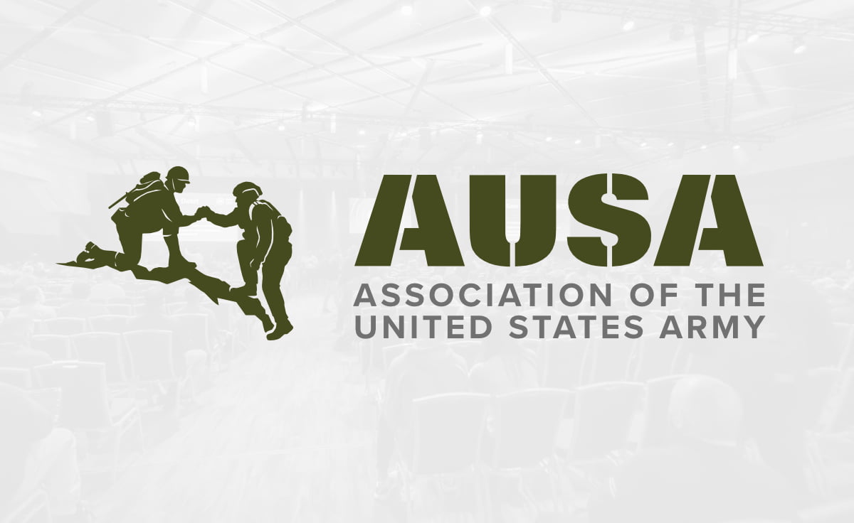 AUSA logo overlayed on a gray opaque background of an event conference